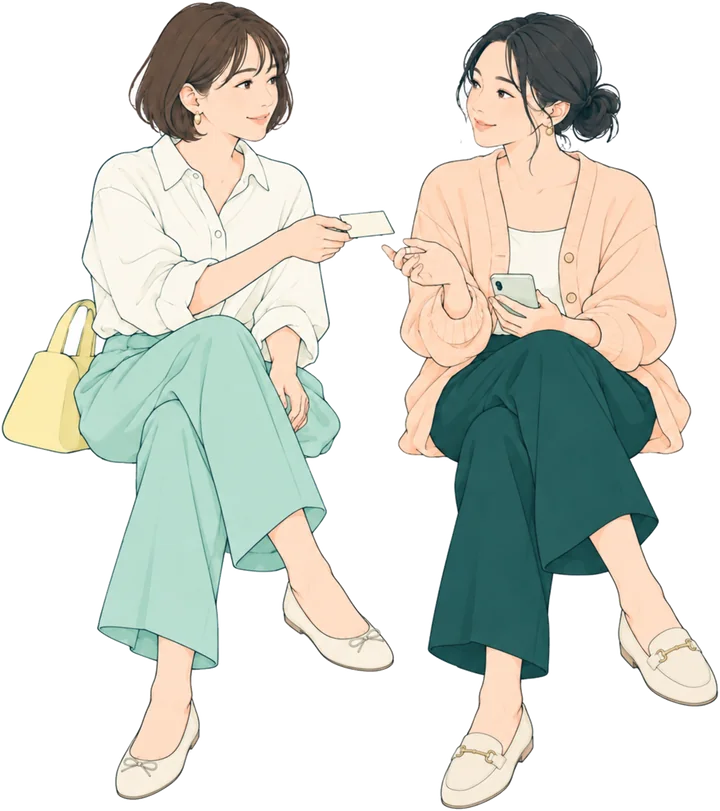 ベンチに並んで座って話している2人。片方がもう片方に小さなカードを差し出している